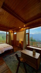 a bedroom with a bed and a table and a screen at Almost Home in Shangarh