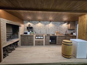 a kitchen with wooden cabinets and a brick wall at Villa Flores in Alicante