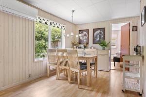 a kitchen and dining room with a table and chairs at LF16084-Farso-Kjeldhoj-84 in Farsø +11 photos