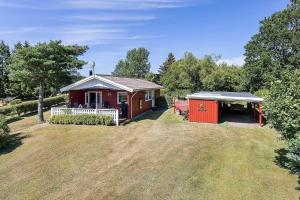 a small red house with a gazebo at LF16024-Farso-Kjeldhoj-24 in Farsø