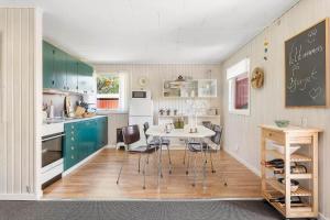 a kitchen with a table and chairs and a chalkboard at LF16024-Farso-Kjeldhoj-24 in Farsø