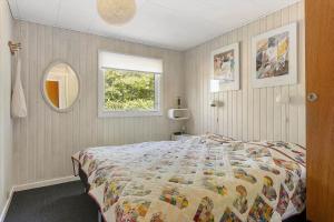 a bedroom with a large bed and a window at LF16024-Farso-Kjeldhoj-24 in Farsø