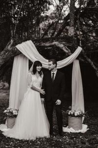 a bride and groom standing in front of a tent at Weaver's Nest Cottage - Nature Retreat! in Gqeberha