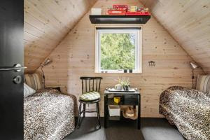 a room with two beds and a window in a attic at LF15103-Farso-Rorsangervej-3 in Farsø