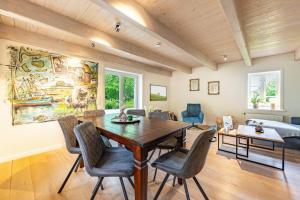 a dining room with a table and chairs and a bed at Ferienhaus Hyggehüs in Risum-Lindholm