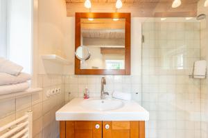 a bathroom with a sink and a mirror at Ferienhaus Hyggehüs in Risum-Lindholm +39 photos