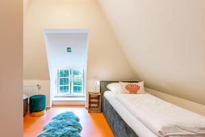 a bedroom with two beds and a rug on the floor at Ferienhaus Hyggehüs in Risum-Lindholm