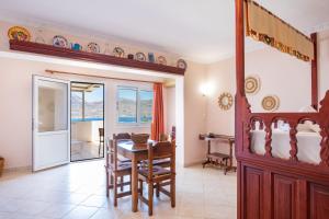 a living room with a table and a dining room at Maria's Studio 1 in Karpathos +19 photos