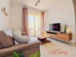 a living room with a couch and a tv at Merhba Court Apartments - St Pauls Bay in St. Paul's Bay