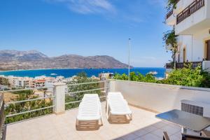 a balcony with chairs and a view of the ocean at Maria's Studio 1 in Karpathos