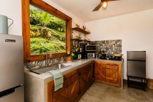 a kitchen with a sink and a window at Finca Ki' - Eco Farm Stay Bed & Breakfast - El Yunque Region in Naguabo +73 photos
