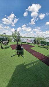 a playground with two swings on the grass at Vila Soleil in Smederevo