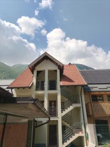 a building with solar panels on top of it at Soča Trails Apartment #6 in Log Čezsoški
