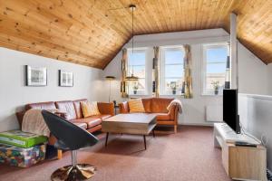 a living room with a couch and a tv at 0407-Romo-Vestergade-225-App-9 in Høm
