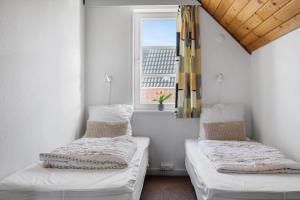two beds in a room with a window at 0407-Romo-Vestergade-225-App-9 in Høm +39 photos