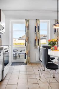 a kitchen with a table and chairs and a dining room at 0407-Romo-Vestergade-225-App-9 in Høm