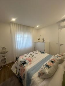 a bedroom with two beds and a window at Os Pimentinhas in Ribeiro +38 photos