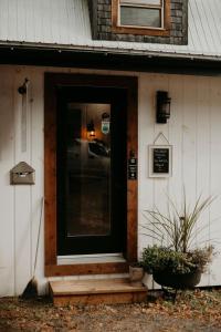 a front door of a house with a porch at Domaine Taïga - Parc animalier en forêt in Sainte-Agathe-des-Monts