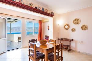 a dining room with a wooden table and a table at Maria's Studio 1 in Karpathos
