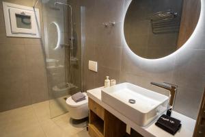a bathroom with a sink and a shower and a toilet at eu Τhea Apt Samos - Sandy Beach & Amazing View in Psili Ammos +48 photos