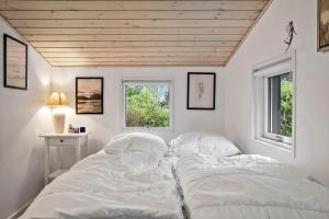 a white bedroom with two beds and two windows at LF15195-Hojslev-Sneppevej-25 in Højslev