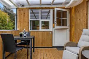 a patio with a table and chairs and a window at LF15195-Hojslev-Sneppevej-25 in Højslev +26 photos
