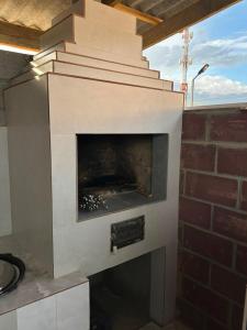 a brick fireplace with a fire place in it at Парус in Cholpon-Ata