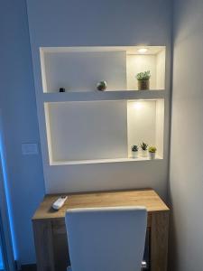 a desk with potted plants on shelves and a chair at Stazione 21 - Pescara Loft in Pescara