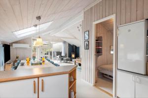 a kitchen and living room with a couch and a table at LF16082-Farso-Kjeldhoj-82 in Ertebølle