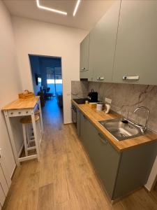 a kitchen with a sink and a counter top at Stazione 21 - Pescara Loft in Pescara