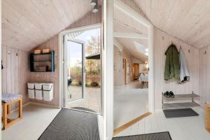 a small house with a hallway with a sliding glass door at LF16082-Farso-Kjeldhoj-82 in Ertebølle
