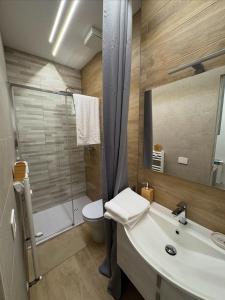 a bathroom with a sink and a toilet and a shower at Stazione 21 - Pescara Loft in Pescara