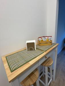 a wooden desk with a counter top with acomputer on it at Stazione 21 - Pescara Loft in Pescara +2 photos