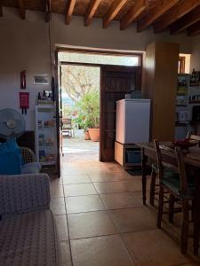 a kitchen with a table and a refrigerator at Avli-the courtyard in Nicosia