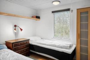 a bedroom with two beds and a window at LF18116-Veslos-Agerovej-6 in Amtoft