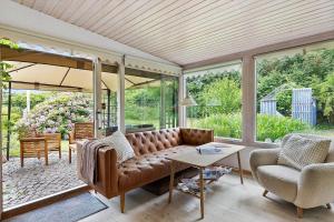 a living room with a couch and a table at FJ1200-Jaegerspris-Planetvej-8 in Jægerspris