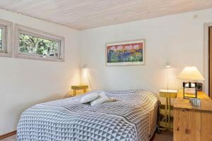 a bedroom with a bed and two windows at FJ1200-Jaegerspris-Planetvej-8 in Jægerspris