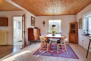 a dining room with a table and chairs at LF10313-Hurup-Thy-Fjordstraede-13 in Doverodde