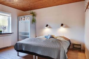 a bedroom with a bed and two lights on the ceiling at LF10313-Hurup-Thy-Fjordstraede-13 in Doverodde