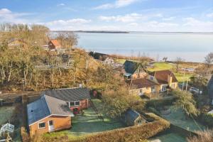 an aerial view of a house next to the water at LF10313-Hurup-Thy-Fjordstraede-13 in Doverodde +17 photos