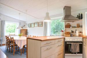 a kitchen with a table and a dining room at 13374-1-Vig-Thorsvej-4 in Vig +14 photos