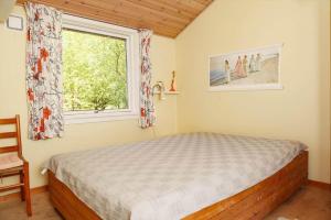 a bedroom with a bed and a window at 13374-1-Vig-Thorsvej-4 in Vig