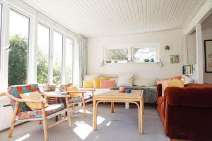 a living room with a couch and a table at 13374-1-Vig-Thorsvej-4 in Vig