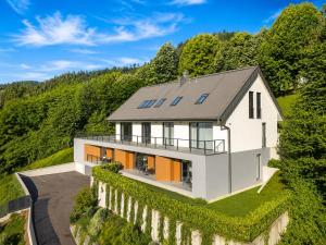 an aerial view of a white house on a hill at Vila Katarina - Lake View Apartments in Bled