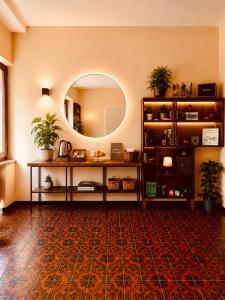 a room with a table with a mirror and a rug at Putechella Slow Living Retrait in Tramonti