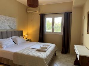 a bedroom with a bed with two towels on it at Georgia in Gythio