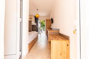 a room with a bench and a bed in it at Haris Hotel by Diomedes Group in Hanioti