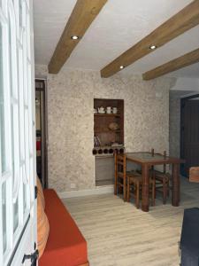 a kitchen with a table and chairs and a counter at Las Casitas de mi Abuela in Casares +71 photos
