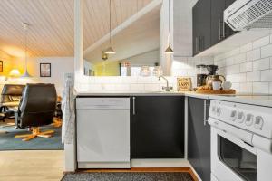 a kitchen with a stove and a dishwasher at LF14348-Roslev-Harrebjergvej-48 in Harre