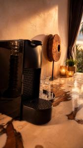 a coffee maker sitting on a counter with a roll at MARRAKECH פלא - PELEH - Queit place 3 km from the beach of Cesarea in Or ‘Aqīvāh +117 photos